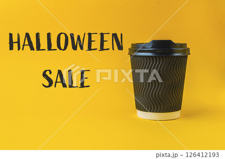 Coffee cup with a Halloween sale sign on it Coffee cup with a Halloween sale sign on it 126412193