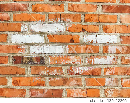 A brick wall with a white line painted on it A brick wall with a white line painted on it 126412263