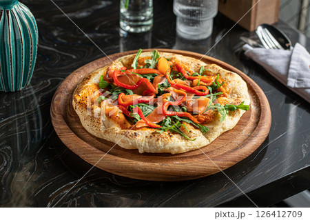 Portion of pizza with salmon and baked pepper 126412709
