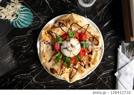 Portion of italian style focaccia with buratta 126412710