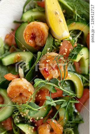 Portion of salad with fresh vegetables and shrimp 126412717