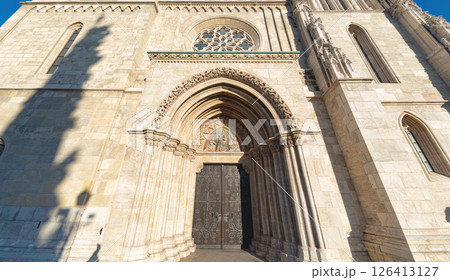 Matthias church facade with ornate carvings and iron doors in budapest hungary Matthias church facade with ornate carvings and iron doors in budapest hungary 126413127
