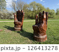 Two Wooden Armchairs Sculpted as Giant Hands in Park 126413278