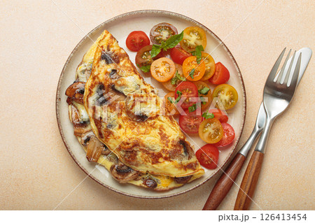 Delicious meal with omelette with mushrooms and cherry tomatoes served on plate, healthy breakfast top view 126413454