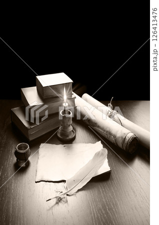 Books and candle on the table 126413476