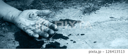 A man's hand in blood lies on the ground A man's hand in blood lies on the ground 126413513