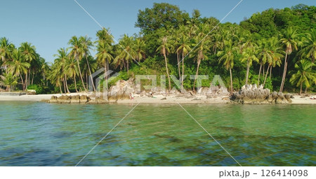 Lush tropical vegetation meets white sand and crystal-clear water in this idyllic Koh Samui beach, offering a perfect escape for tourists seeking relaxation and natural beauty in Thailand Lush tropical vegetation meets white sand and crystal-clear water in this idyllic Koh Samui beach, offering a perfect escape for tourists seeking relaxation and natural beauty in Thailand 126414098