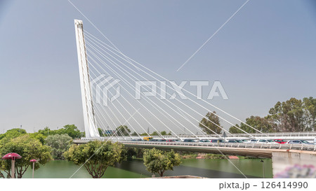 Alamillo Bridge with tall pylon and steel cables crossing over Guadalquivir River timelapse hyperlapse in Seville, Spain 126414990