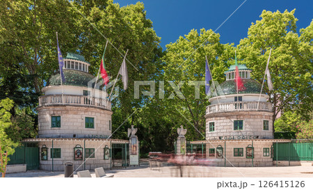 Timelapse hyperlapse of Lisbon Zoo entrance with open gates and flags on towers during summer. Lisbon, Portugal 126415126