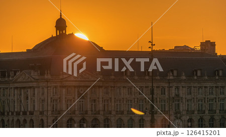 Sunset view of Bordeaux city skyline featuring spires and rooftops on a waterfront. Sunset view of Bordeaux city skyline featuring spires and rooftops on a waterfront. 126415201