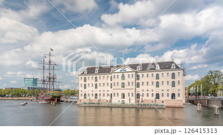 Hyperlapse of the National Maritime Museum with the sailboat replica Amsterdam docked nearby. Amsterdam, Netherlands Hyperlapse of the National Maritime Museum with the sailboat replica Amsterdam docked nearby. Amsterdam, Netherlands 126415313