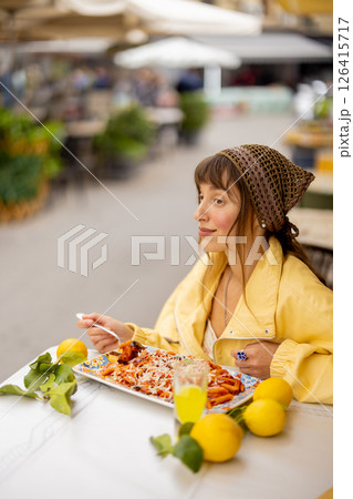 Happy woman enjoying Sicilian pasta 126415717