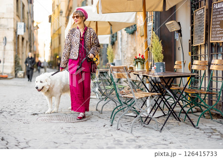 Woman walking dog on Roman street 126415733