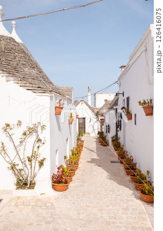 Trulli alley with flower pots in Alberobello Trulli alley with flower pots in Alberobello 126416075