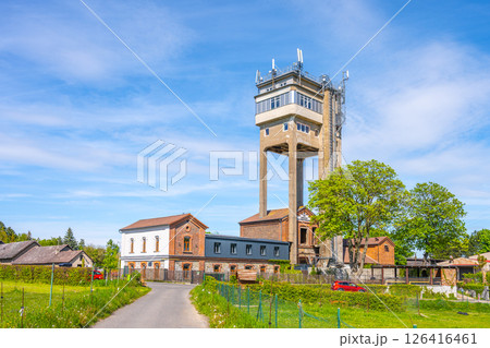 Rudolfka lookout tower stands prominently in Bohutin, Czechia, showcasing its former mining heritage. Visitors can admire the unique architecture under a clear blue sky. 126416461