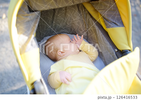 Newborn baby sucks his thumb and falls asleep 126416533