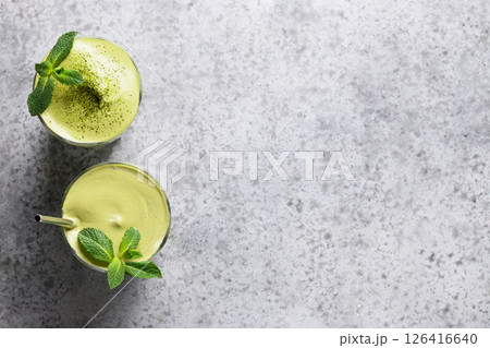 Dalgona matcha latte tea, bamboo whisk and matcha powder on gray. 126416640