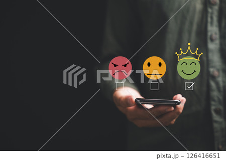 Close-up of customer hand rating service with 5 star feedback icon on smartphone on black background. Online survey, review and satisfaction concept for business success, give five stars good service 126416651