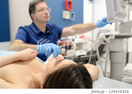 Mammologist doctor examines a woman breasts and lymph nodes using ultrasound. Mammography and ultrasound scanning are main methods of instrumental diagnosis of mammary glands. Breast cancer 126416928