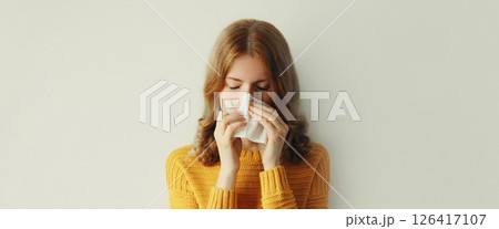 Sick exhausted young woman sneezing blow nose using tissue, unhealthy suffering girl feels unwell 126417107