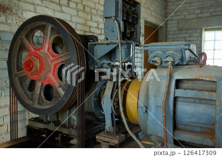 An Industrial Machine is situated in an Abandoned Setting, showcasing its decaying beauty 126417309