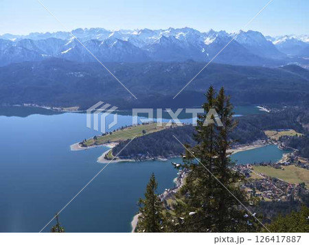Stunning mountain landscape featuring serene lakes and vibrant greenery in the Alps on a clear sunny day Stunning mountain landscape featuring serene lakes and vibrant greenery in the Alps on a clear sunny day 126417887
