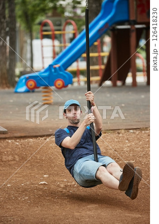Man playing on playground 126418230