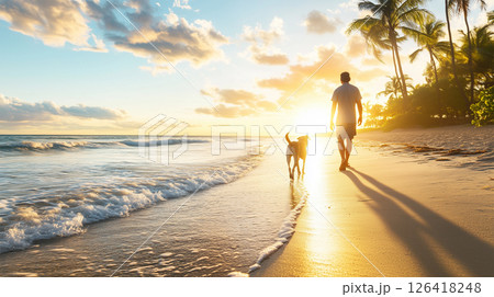 夕日に照らされる砂浜を散歩する男性と犬 126418248