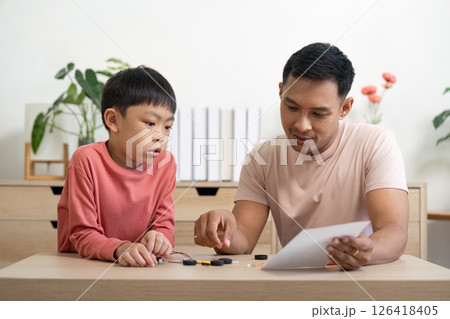 Activity of father teaching son through hands-on project exploration 126418405