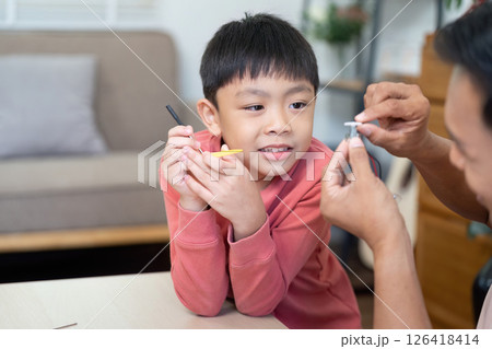 Activity of father and son having fun with DIY learning tools 126418414
