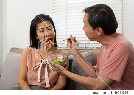 Wellness and Nutrition. Elderly couple enjoying healthy meal together at home. Wellness and Nutrition. Elderly couple enjoying healthy meal together at home. 126418444