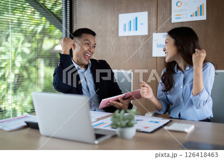 Celebrating Success. Two colleagues expressing joy in achieving business goals. Celebrating Success. Two colleagues expressing joy in achieving business goals. 126418463