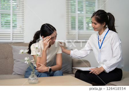 Psychologist and Patient. A psychologist offers empathy to a patient expressing emotional distress in therapy. 126418554