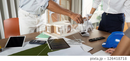 Sustainability engineers expertly finalizing project designs at their workstation Sustainability engineers expertly finalizing project designs at their workstation 126418718