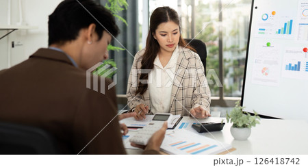 Collaborative Financial Planning. Professionals analyzing budget reports in a modern office. 126418742