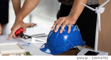 Sustainability focus with engineer planning renewable energy projects 126418762