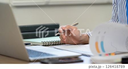 Professional Writing. Close-up of a hand taking notes during a work session. 126418789