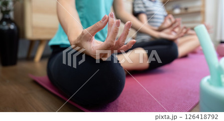 Wellness Meditation: Mother and daughter practicing mindfulness Wellness Meditation: Mother and daughter practicing mindfulness 126418792