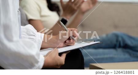 Therapeutic Interaction. A psychologist engaging with a young woman during a mental health session. Therapeutic Interaction. A psychologist engaging with a young woman during a mental health session. 126418801
