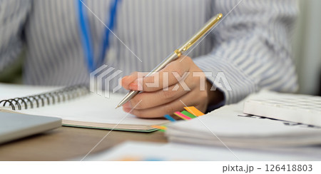 Note-taking and Organization. Business professional writing in a notebook. Note-taking and Organization. Business professional writing in a notebook. 126418803