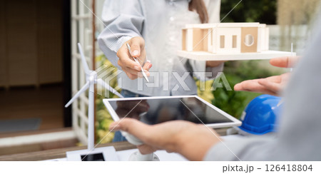 Sustainability engineer collaborating on renewable energy design models Sustainability engineer collaborating on renewable energy design models 126418804