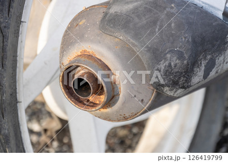 Close-up of a corroded motorcycle exhaust pipe in rusty condition in a mechanical environment Close-up of a corroded motorcycle exhaust pipe in rusty condition in a mechanical environment 126419799
