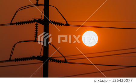 Sunset view over power lines energy infrastructure urban landscape evening horizon 126420077