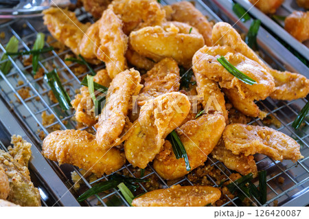 Crispy fried chicken bites local market food vibrant setting close-up culinary delight Crispy fried chicken bites local market food vibrant setting close-up culinary delight 126420087