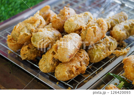 Crispy fried snacks street market food urban setting close-up culinary delight Crispy fried snacks street market food urban setting close-up culinary delight 126420093