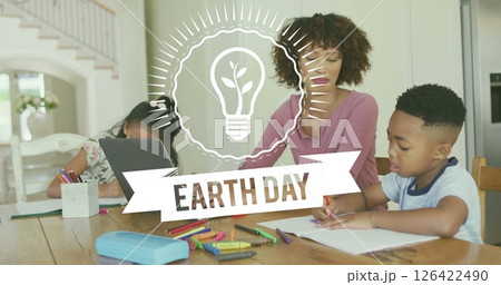 Earth Day image over family drawing and using laptop at home Earth Day image over family drawing and using laptop at home 126422490