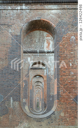 he semi-circular arches vaulting supporting traditional red brick piers with smooth limestone. 126422498