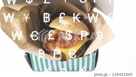 Burger with bacon and cheese in box over currency symbols image 126422805
