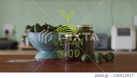 Vegan food locally grown image over fresh vegetables and jars on kitchen counter 126422817