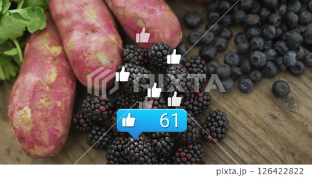 Social media likes image over fresh blackberries, blueberries, and sweet potatoes 126422822